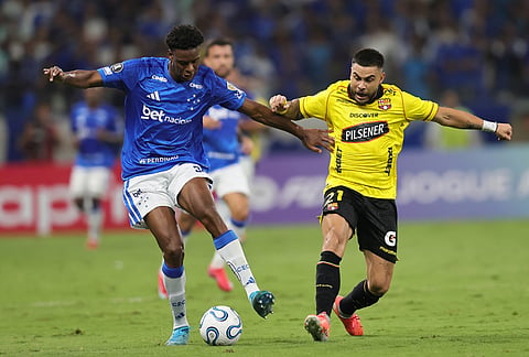 Jonathan Jesus of Brazil's Cruzeiro, left, and Hector Villalba of Ecuador's Barcelona battle for the ball during a Copa Libertadores Group D soccer match in Belo Horizonte, Brazil.