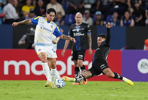 Enzo Gimenez of Argentina's Rosario Central, left, and Jordy Alcivar of Ecuador's Independiente del Valle fight for the ball during a Copa Libertadores Group H soccer match in Quito, Ecuador.