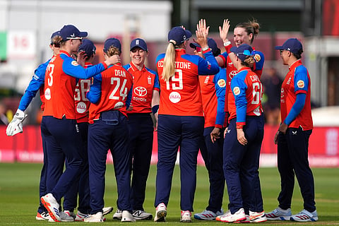 England's players celebrate the wicket of India's Smriti Mandhana during the first Vitality IT20 cricket match between England and India in Chelmsford, England.