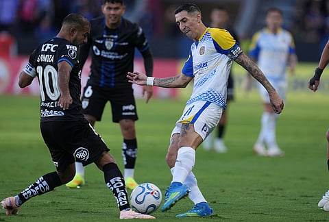 Junior Sornoza of Ecuador's Independiente del Valle, left, and Angel Di Maria of Argentina's Rosario Central compete for the ball during a Copa Libertadores Group H soccer match in Quito, Ecuador.