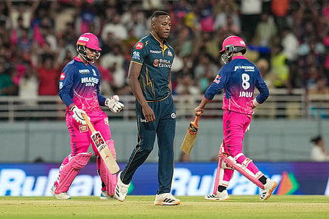 Gujarat Titans' Kagiso Rabada, centre, returns after bowling a delivery as Rajasthan Royals' Ravindra Jadeja, right, and Vaibhav Sooryavanshi run between the wickets during the Indian Premier League (IPL) 2026 Qualifier 2 T20 cricket match between Gujarat Titans and Rajasthan Royals, in New Chandigarh.
