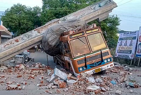 A truck lies trapped under the collapsed entrance arch of the Chettikulam Murugan Temple after it crashed into the structure, in Perambalur district, Tamil Nadu.