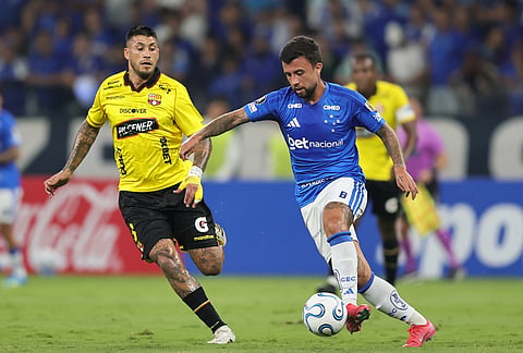 Matheus Henrique of Brazil's Cruzeiro, right, is challenged by Milton Celiz of Ecuador's Barcelona during a Copa Libertadores Group D soccer match in Belo Horizonte, Brazil.