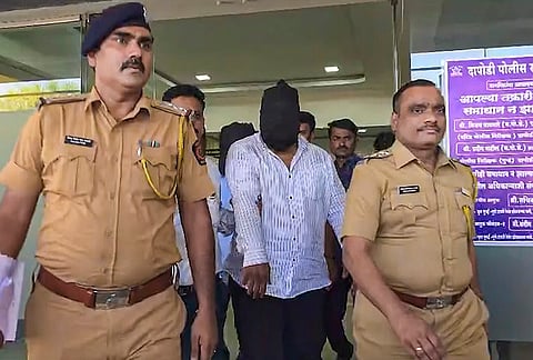 Police personnel escort an accused in connection with the suspected spurious liquor tragedy that claimed multiple lives in Phugewadi and Hadapsar areas, in Pune.