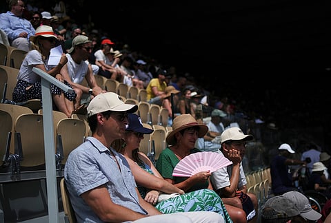 Spectators watch the third round women's singles tennis match between Magda Linette of Poland and Iga Swiatek of Poland at the French Open tennis tournament in Paris.