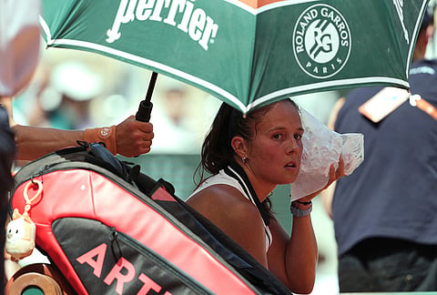 Daria Kasatkina of Australia cools herself with ice during the break of the third round women's singles tennis match against Aryna Sabalenka of Belarus at the French Open tennis tournament in Paris.