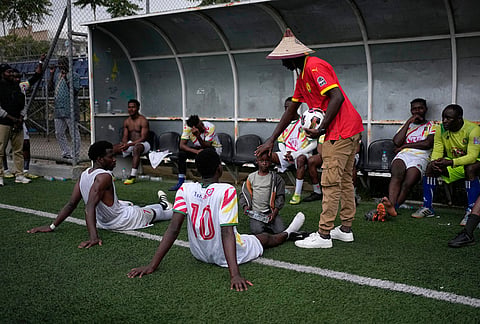 The coach of Guinea instructs his players before the start of the second half against Afghanistan during the Kypseli Mundial in Athens, Greece.