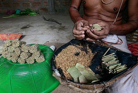 A worker rolls bidis, hand-rolled tobacco wrapped in tendu leaves, on the eve of World No Tobacco Day, in Agartala, Tripura.