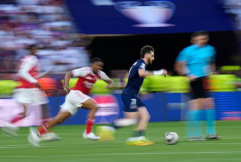 PSG's Khvicha Kvaratskhelia runs with the ball during the Champions League final soccer match between Paris Saint-Germain and Arsenal in Budapest, Hungary.