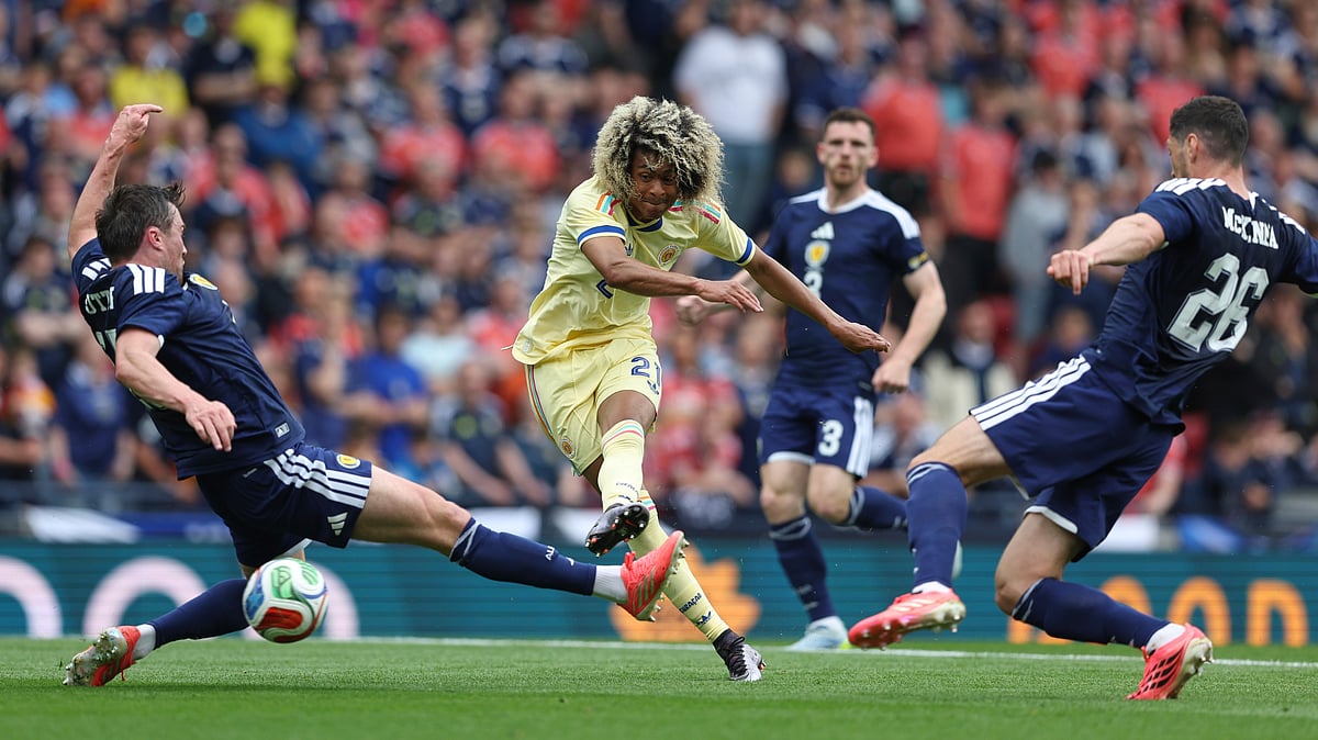 Tahiti Chong, center, shoots and scores the opening goal during an international friendly soccer match between Scotland and Curacao in Glasgow - AP