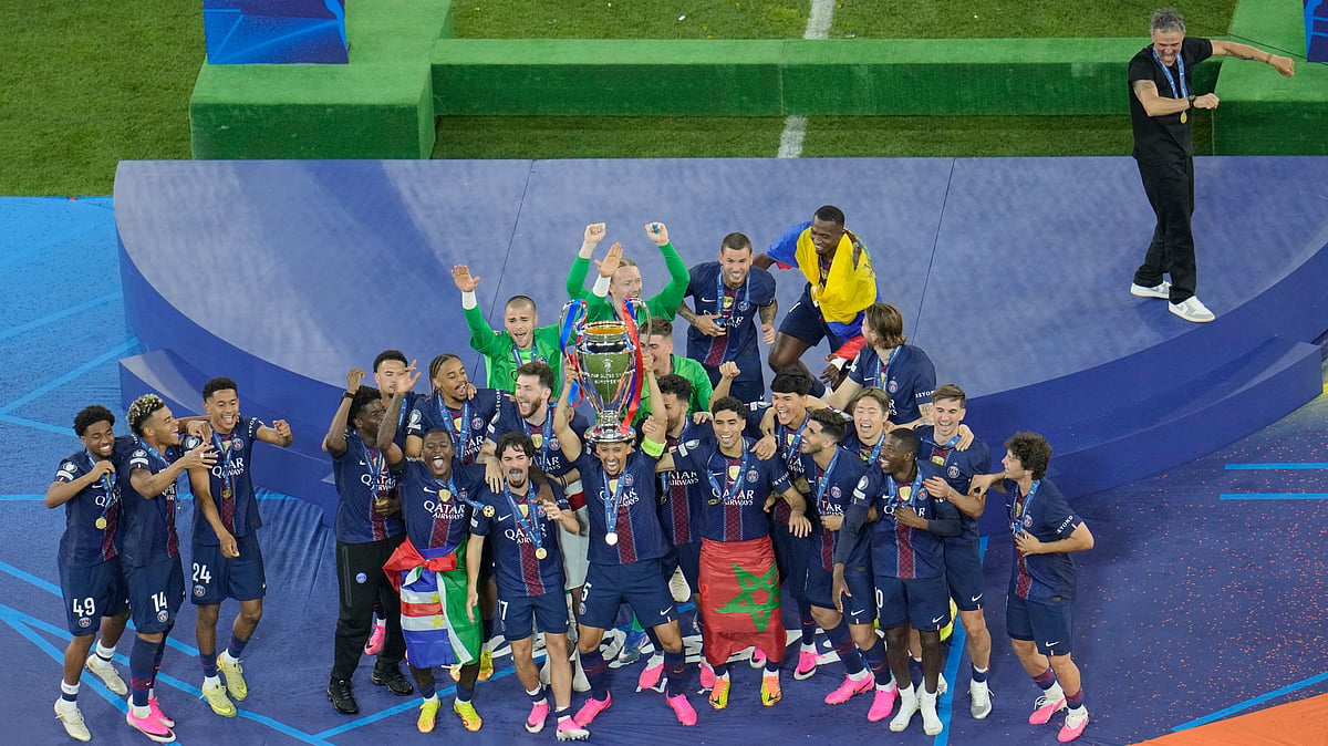 PSG players celebrate with the trophy after winning the Champions League final soccer match against Arsenal in Budapest, Hungary. - AP