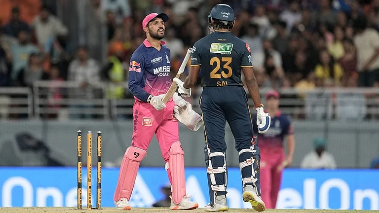 Rajasthan Royals' Dhruv Jurel hands over bat to Gujarat Titans' Sai Sudharsan after Sudharsan got out by dropping his own bat on to his wickets during the Indian Premier League cricket match between Gujarat Titans and Rajasthan Royals in New Chandigarh, India. - | Photo: AP/Ashwini Bhatia