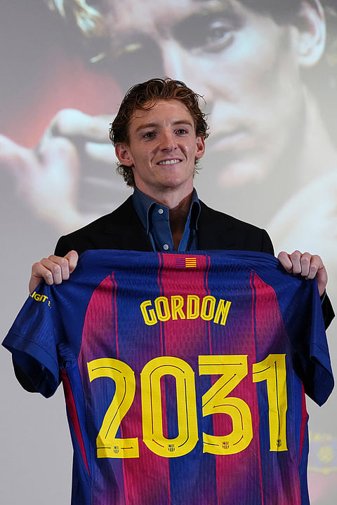 Barcelona new signing soccer player Anthony Gordon poses with his jersey during his official presentation in Barcelona, Spain.