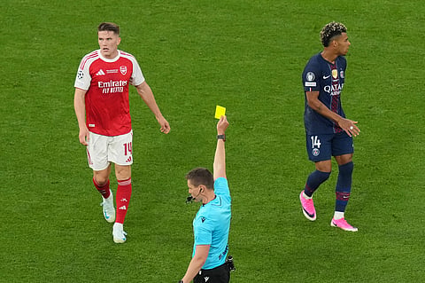 Referee Daniel Siebert shows a yellow card to Arsenal's Viktor Gyokeres, left, during the Champions League final soccer match between Paris Saint-Germain and Arsenal in Budapest, Hungary.