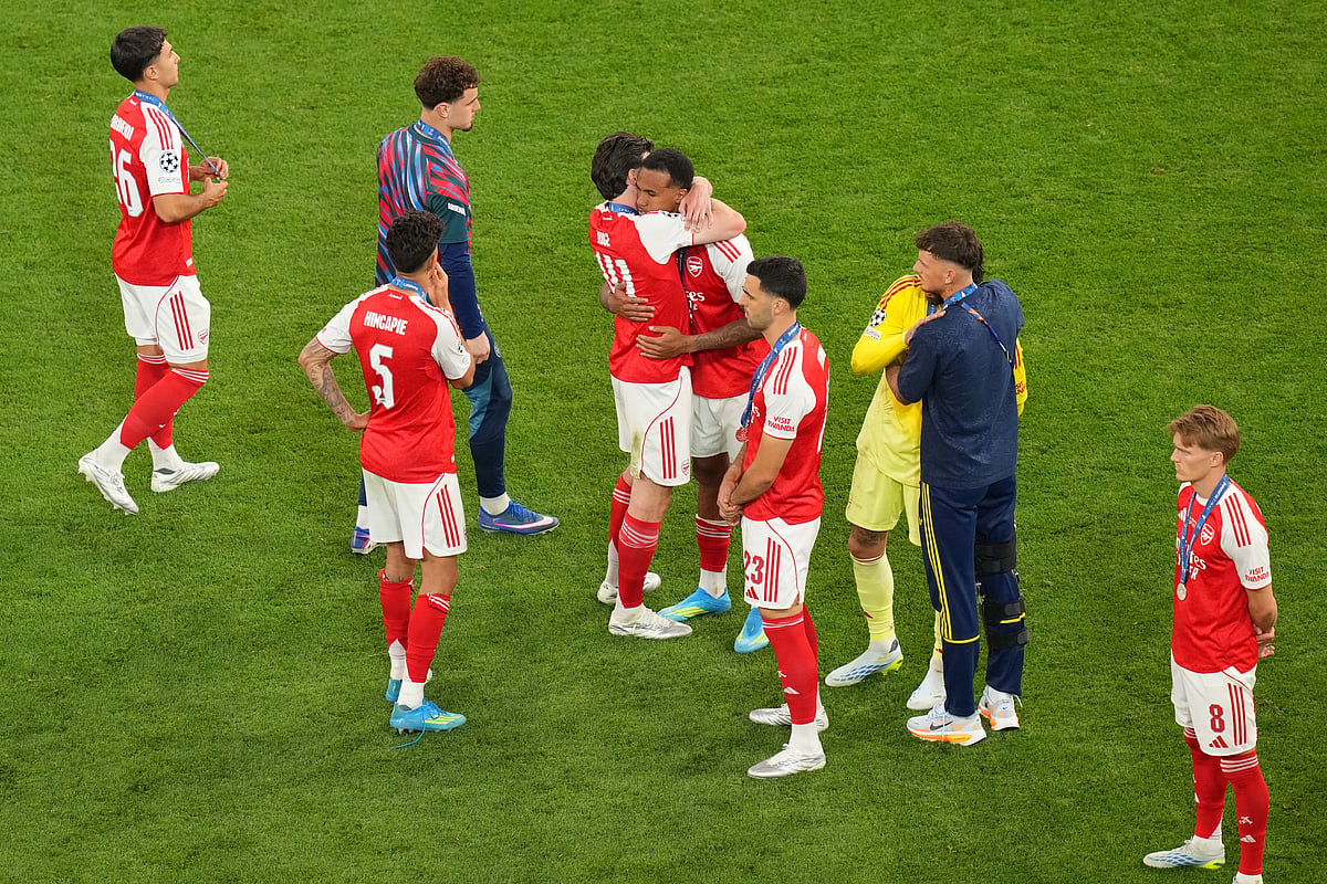 Arsenal players react after losing the Champions League final soccer match between Paris Saint-Germain and Arsenal in Budapest