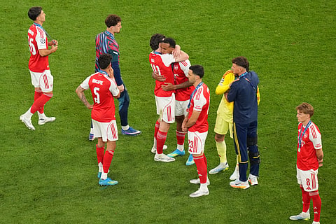Arsenal players react after losing the Champions League final soccer match between Paris Saint-Germain and Arsenal in Budapest