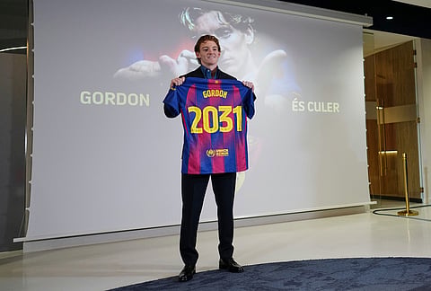 Barcelona new signing soccer player Anthony Gordon poses with his jersey during his official presentation in Barcelona, Spain.