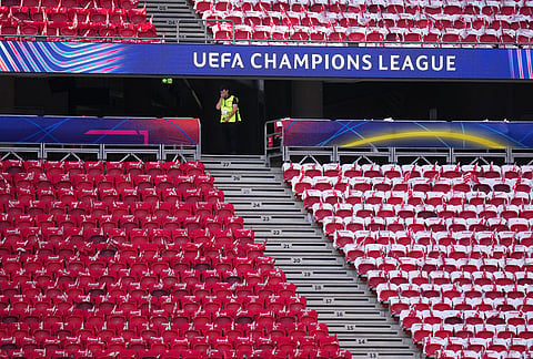 Red and white flags are laid on seats for Arsenal fans, at the stadium, ahead of the Champions League final soccer match between Paris Saint-Germain and Arsenal in Budapest, Hungary.