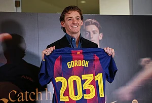 | Photo: AP/Joan Mateu : Barcelona new signing soccer player Anthony Gordon poses with his jersey during his official presentation in Barcelona, Spain.