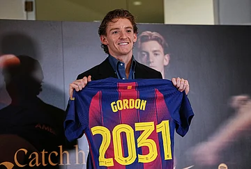 | Photo: AP/Joan Mateu : Barcelona new signing soccer player Anthony Gordon poses with his jersey during his official presentation in Barcelona, Spain.