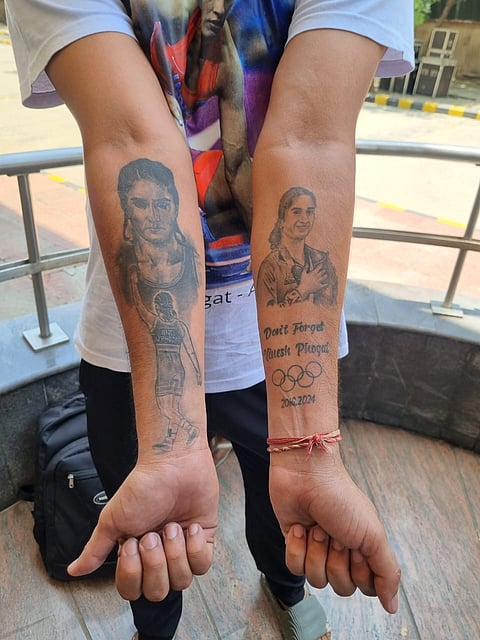 Vinesh Phogat's fan Manoj Dahiya turned heads at the Asian Games 2026 wrestling selection trials, arriving with tattoos of the wrestler's face on both his arms and wearing a T-shirt featuring her picture in a show of unwavering support.