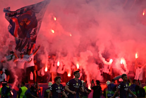 PSG fans celebrate after PSG's Ousmane Dembele scoring his side's opening goal during the Champions League final soccer match between Paris Saint-Germain and Arsenal in Budapest, Hungary.