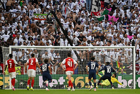 PSG's Ousmane Dembele, right, scores his side's opening goal from penalty spot during the Champions League final soccer match between Paris Saint-Germain and Arsenal in Budapest, Hungary.