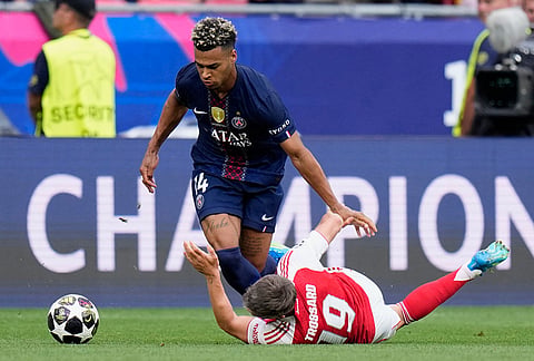 Arsenal's Leandro Trossard falls to the ground in a clash with PSG's Desire Doue during the Champions League final soccer match between Paris Saint-Germain and Arsenal in Budapest, Hungary.