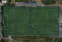 | Photo: AP/Thanassis Stavrakis : An amateur soccer field is seen from above as migrant teams from Guinea and Afghanistan play soccer during the Kypseli Mundial in Athens, Greece.