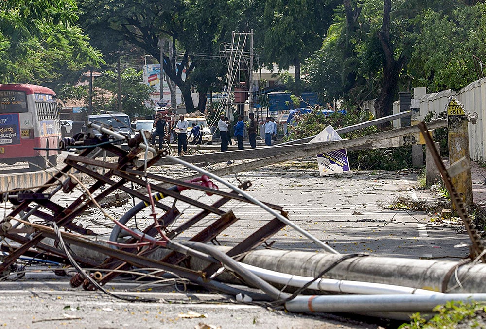 Chikkamagaluru: Electric poles damaged due to strong winds and rainfall are seen, in Chikkamagaluru, Karnataka.  - | Photo: PTI 