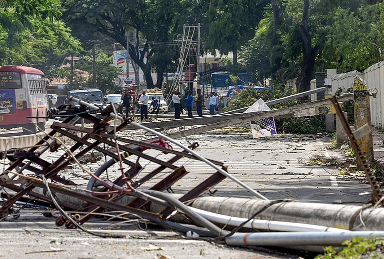 Chikkamagaluru: Electric poles damaged due to strong winds and rainfall are seen, in Chikkamagaluru, Karnataka. - | Photo: PTI