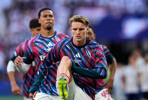 Arsenal's Martin Odegaard exercises during warmup before the Champions League final soccer match between Paris Saint-Germain and Arsenal in Budapest, Hungary.