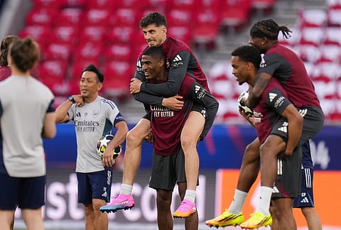 Arsenal's Kai Havertz, center, is carried by teammate Cristhian Mosquera during a training session ahead of the Champions League final soccer match between Paris Saint-Germain and Arsenal in Budapest, Hungary.