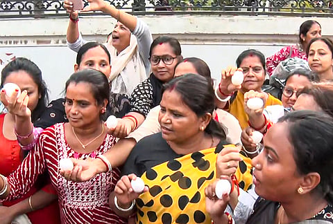 Women throw eggs at TMC General Secretary Abhishek Banerjee, unseen, during his visit to the families of post-poll violence victims, in Sonarpur, West Bengal.