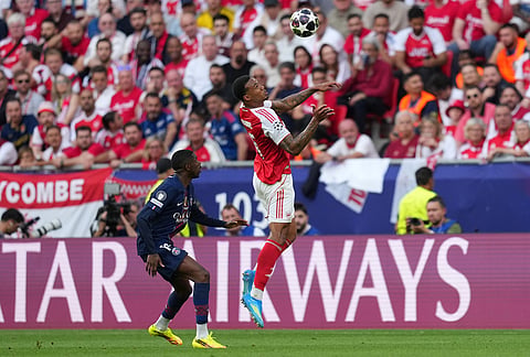 PSG's Ousmane Dembele challenges for the ball with Arsenal's Piero Hincapie during the Champions League final soccer match between Paris Saint-Germain and Arsenal in Budapest, Hungary.