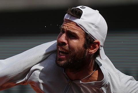 Sweats fly off as Karen Khachanov of Russia returns to Arthur Gea of France during the first round men's singles tennis match at the French Open tennis tournament in Paris.