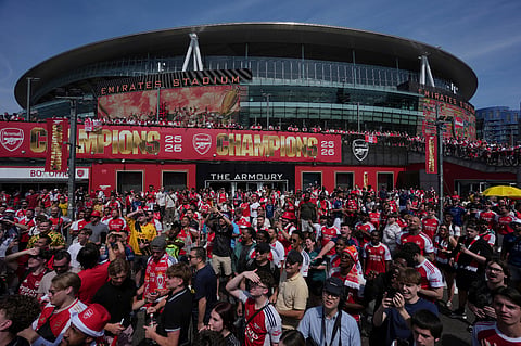 Arsenal supporters gather near the Emirates stadium in London, Saturday, May 30, 2026 while they wait to watch the Champions League final soccer match between Paris Saint-Germain and Arsenal that's being played in Budapest