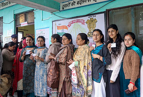 Voters stand in a queue to cast their votes during the final phase of the Panchayat elections, in Shimla, Himachal Pradesh.