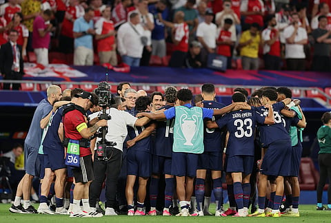 PSG players huddle before the penalty shoot out during the Champions League final soccer match between Paris Saint-Germain and Arsenal in Budapest, Hungary.