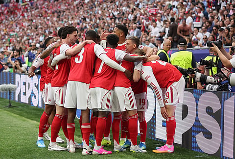 Arsenal players celebrate after scoring during the Champions League final soccer match between Paris Saint-Germain and Arsenal in Budapest, Hungary.