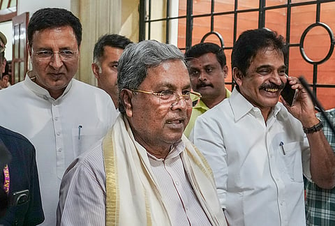 Congress leader and former Karnataka chief minister Siddaramaiah, centre, and party leaders KC Venugopal, right, and Randeep Singh Surjewala arrive to attend the Congress legislature party meeting at Vidhana Soudha, in Bengaluru.