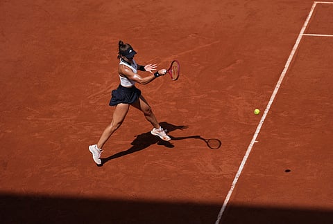 Iva Jovic of the U.S. returns to Naomi Osaka of Japan during their third round women's singles tennis match at the French Open tennis tournament in Paris.