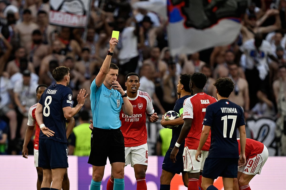 Referee Daniel Siebert shows a yellow card to Arsenal's Bukayo Saka during the Champions League final soccer match between Paris Saint-Germain and Arsenal in Budapest, Hungary, Saturday, May 30, 2026. - AP