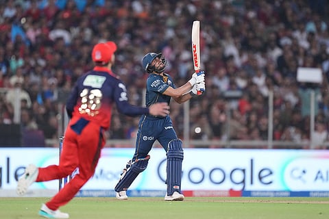 Gujarat Titans' captain Shubman Gill watches after hitting a shot which was taken as catch by Royal Challengers Bengaluru's captain Rajat Patidar during the Indian Premier League final cricket match between Gujarat Titans and Royal Challengers Bengaluru in Ahmedabad, India.