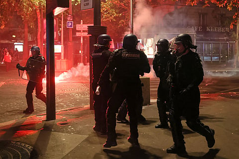 Police try to disperses PSG supporters who left off fireworks as they celebrate in Paris, Saturday, May 30, 2026 after the Champions League final soccer match between Paris Saint-Germain and Arsenal that was played in Budapest. PSG won the game.