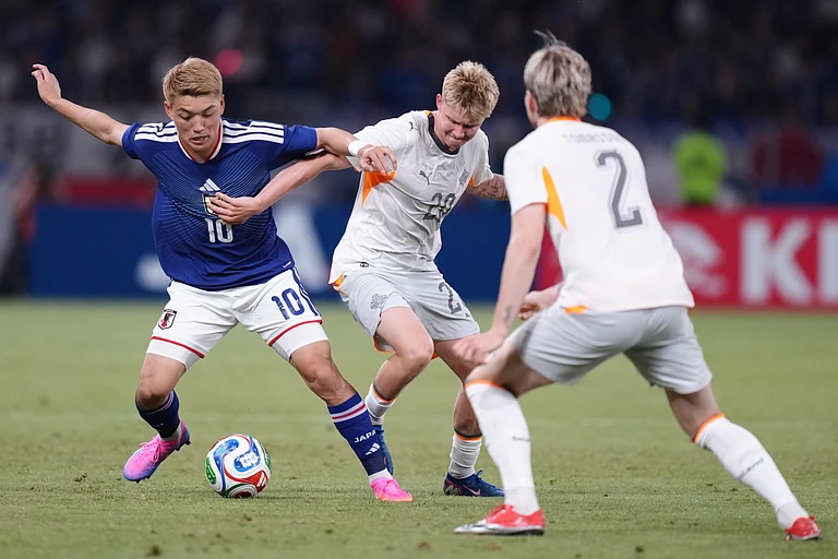 Ritsu Doan of Japan, left, and Kristian Hlynsson of Iceland compete for the ball during the friendly soccer international match. - Eugene Hoshiko/AP