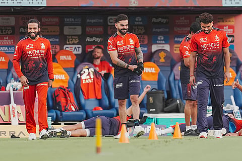 Royal Challengers Bengaluru's captain Rajat Patidar, left, Virat Kohli, centre, and Abhinandan Singh during the warm-up before an Indian Premier League (IPL) 2026 Final T20 cricket match between Royal Challengers Bengaluru and Gujarat Titans, in Ahmedabad, Gujarat.