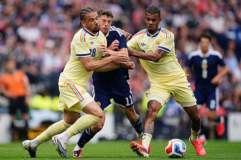Scotland's Ryan Christie in action with Curacao's Armando Obispo, left, and Juninho Bacuna during an international friendly match between Scotland and Curacao in Glasgow.