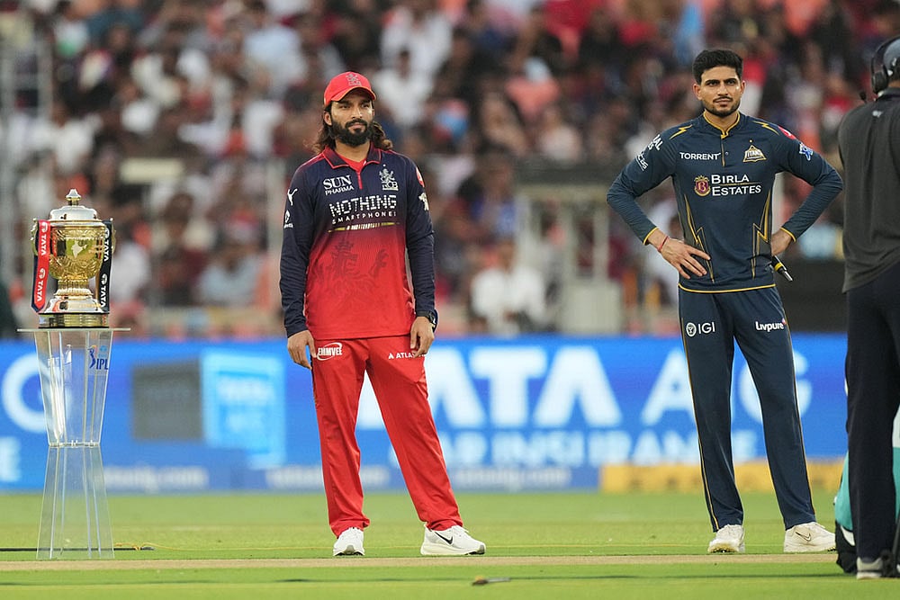 | Photo: AP/Ajit Solanki : Gujarat Titans' captain Shubman Gill and Royal Challengers Bengaluru's captain Rajat Patidar pose with the winners trophy during the toss before the start of the cricket match between Gujarat Titans and Royal Challengers Bengaluru in Ahmedabad, India.