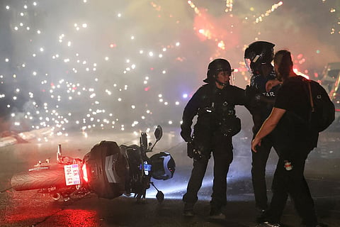 Police try to disperses PSG supporters who left off fireworks as they celebrate in Paris, Saturday, May 30, 2026 after the Champions League final soccer match between Paris Saint-Germain and Arsenal that was played in Budapest. PSG won the game.
